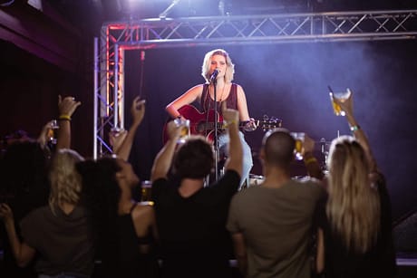 Female performer singing during music event at nightclub