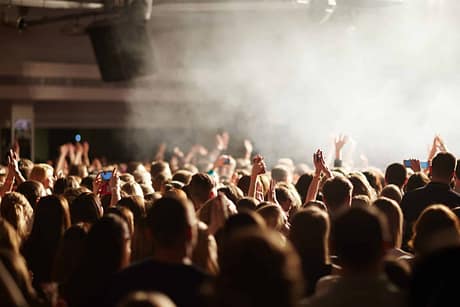 Crowd of clubbers enjoying concert of singer